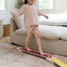 Child standing on a balance beam in a living room