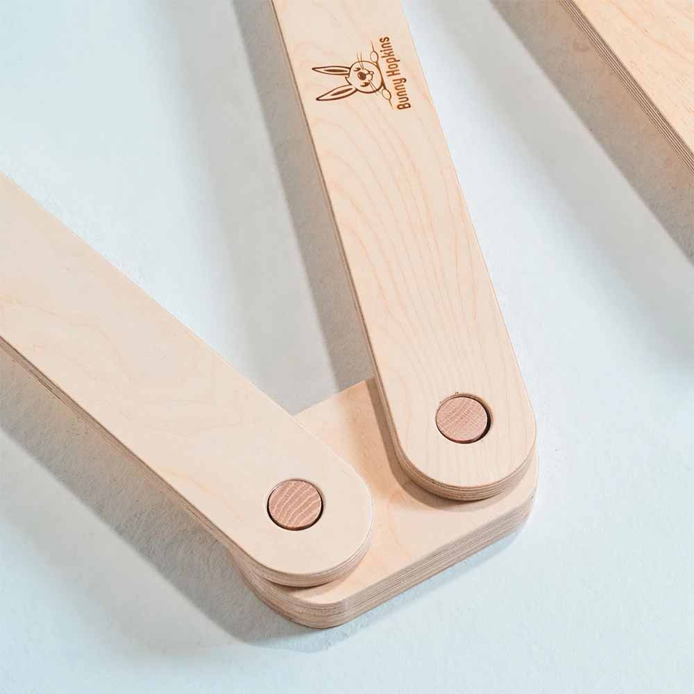 Wooden balance beam with a brand logo on a white background