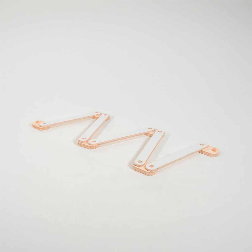 White and natural colored wooden balance beam on a light gray background