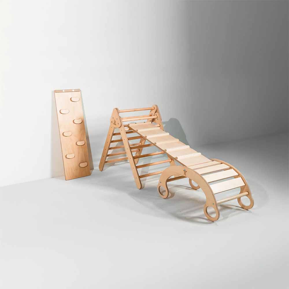Wooden climbing toy set with a slide and ladder on a gray background
