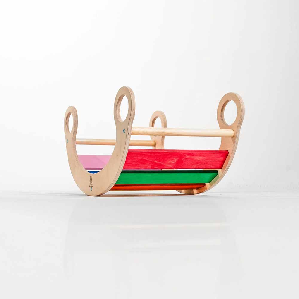 Wooden rocker with colorful slats on a white background