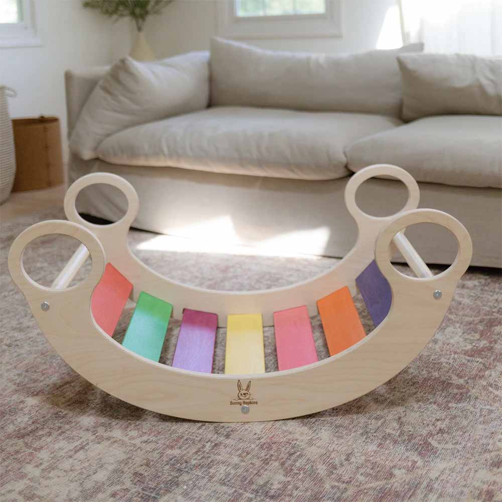 Wooden rocker with colorful bars on a carpeted floor in a living room.