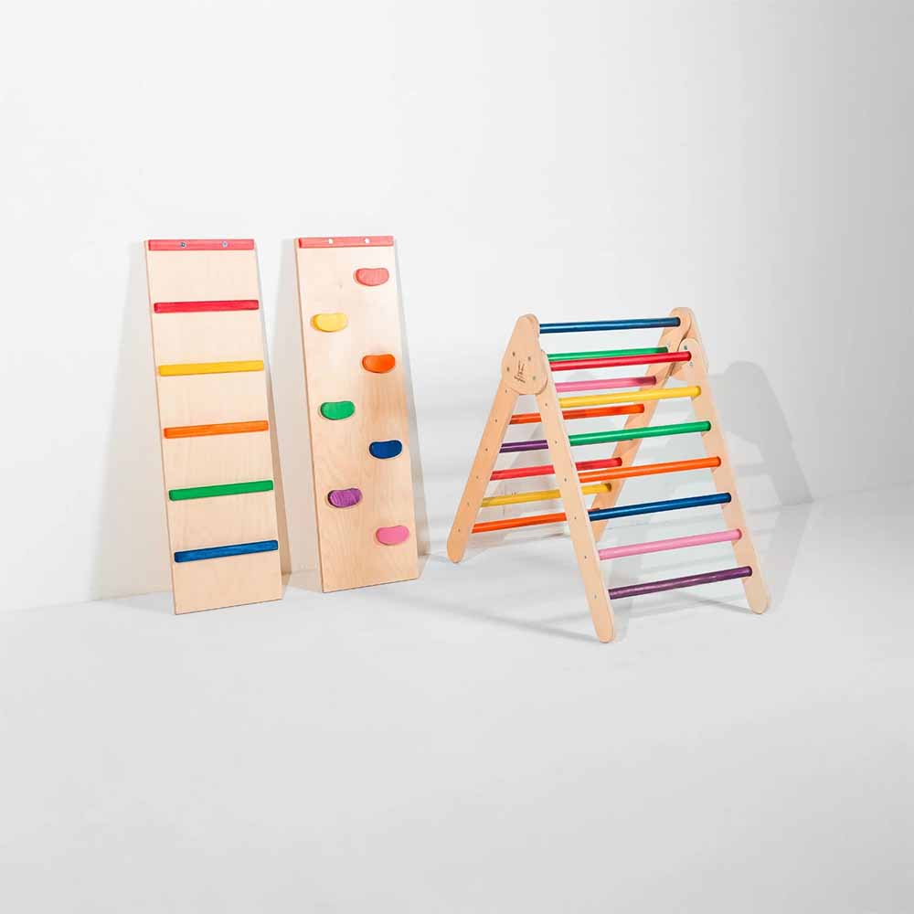 Set of wooden climbing toys with colorful rungs on a white background