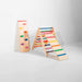 Colorful wooden climbing toy with a slide on a white background