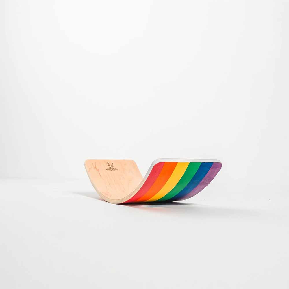 Wooden toy with rainbow design on a white background