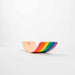Wooden toy with rainbow design on a white background