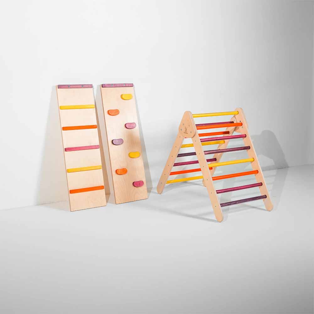 Two wooden climbing toys with colorful steps and a colorful wooden climbing triangle on a white background