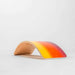 Wooden wobble board with a gradient from red to yellow on a light gray background