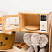 Wooden toy microwave and elephant toy on a white background