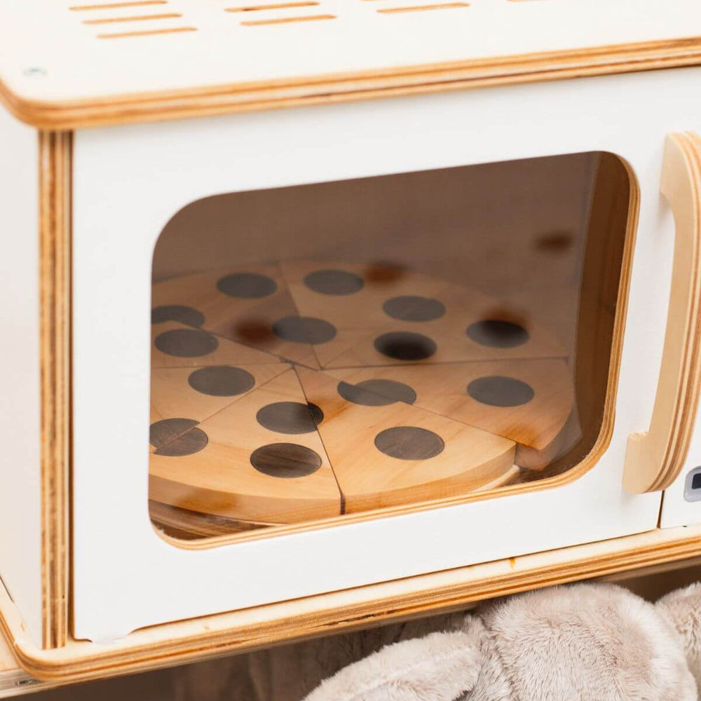 Wooden microwave toy with transparent door heating up wooden toy pizza