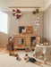 Children's playroom with wooden furniture, toys, and decorative items.