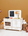 Children's play kitchen set with toys on a beige background