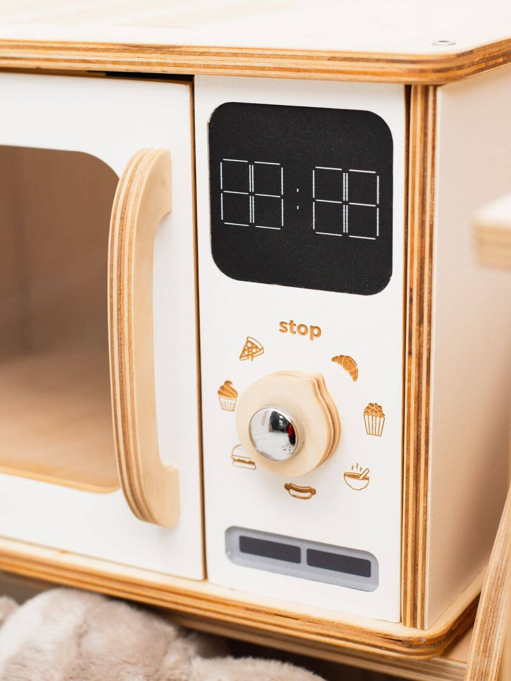 Close up of wooden white microwave play appliance knobs, settings, and pretend display