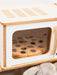 Wooden toy pizza cooking in a white wooden toy microwave