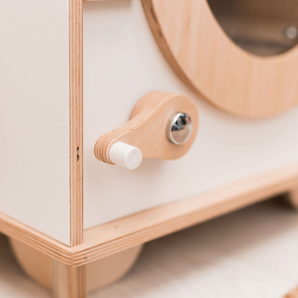 Close-up of a wooden door lock for play washing machine on a light background