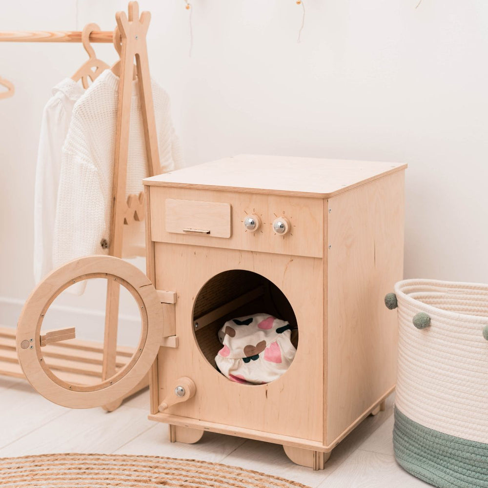Wooden toy washing machine with a basket and clothes rack in a room setting