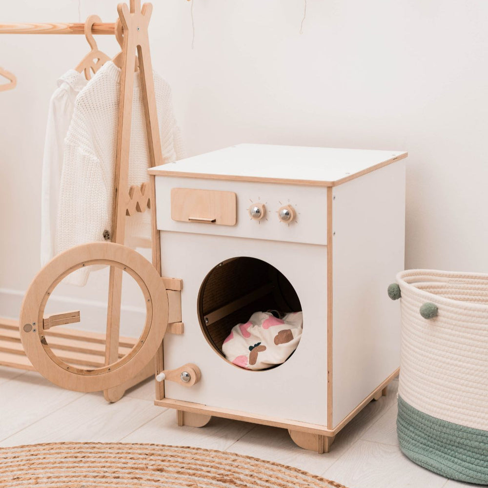 Children's play area with wooden washing machine toy.