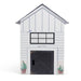 White toy barn with black door and window on a white background