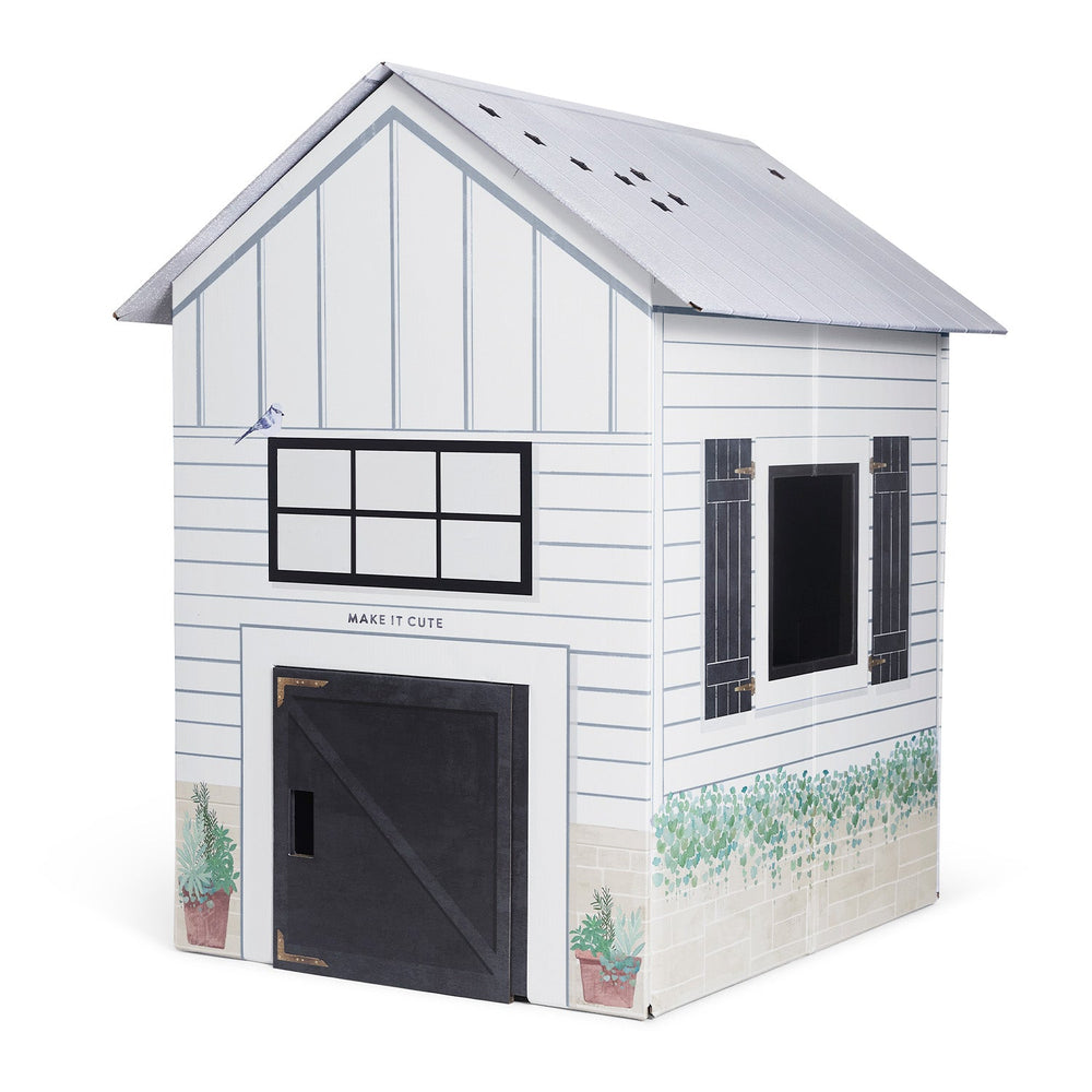 White toy house with black accents on a white background