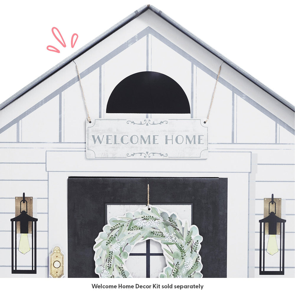 Decorative play house with 'Welcome Home' sign and wreath on a white background
