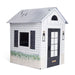 Playhouse with white walls, gray roof, and black door on a white background