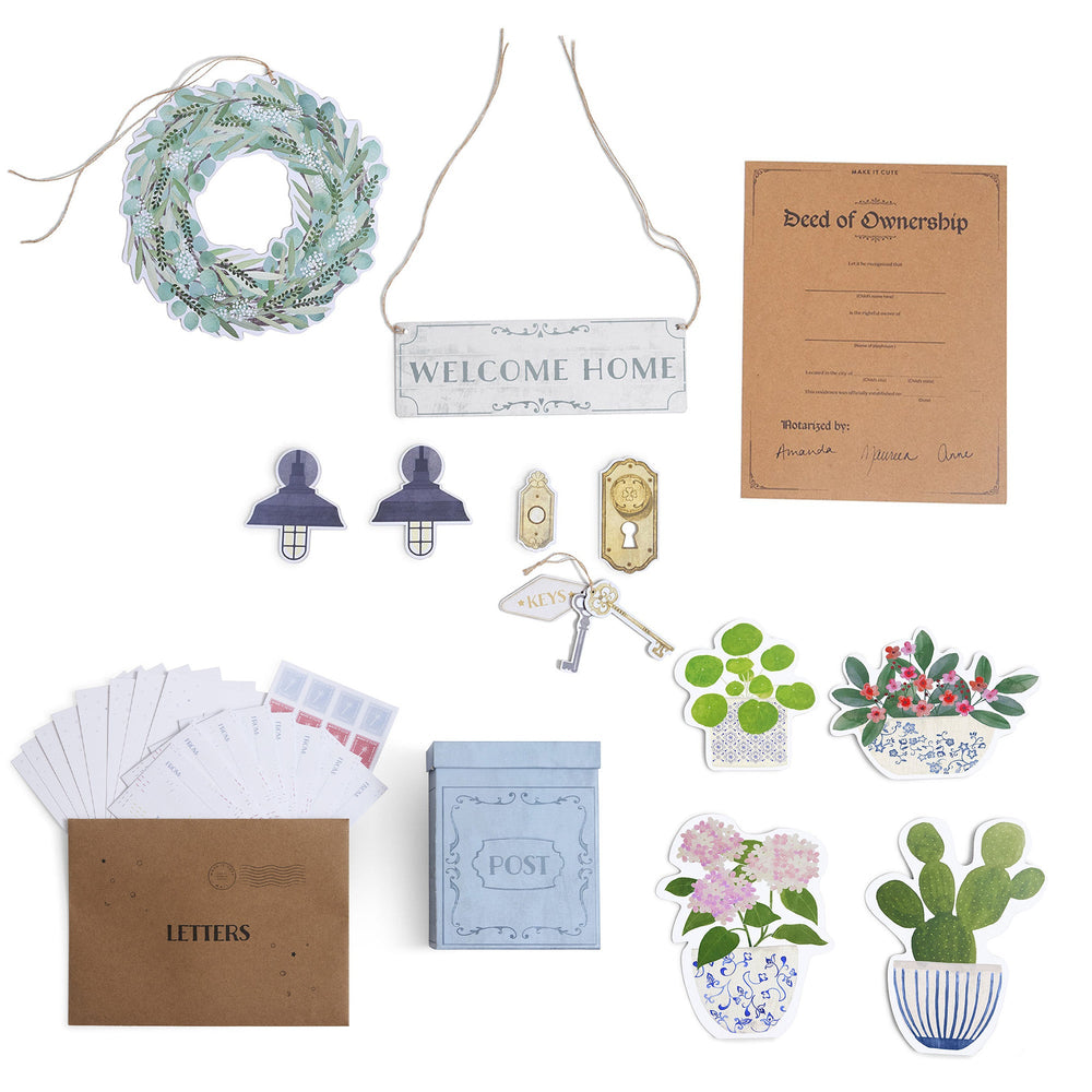 Collection of home decor items for a playhouse including a wreath, welcome sign, keychain, and stationery on a white background.