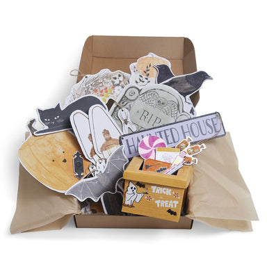 Collection of Halloween-themed paper cutouts and decorations in a box.