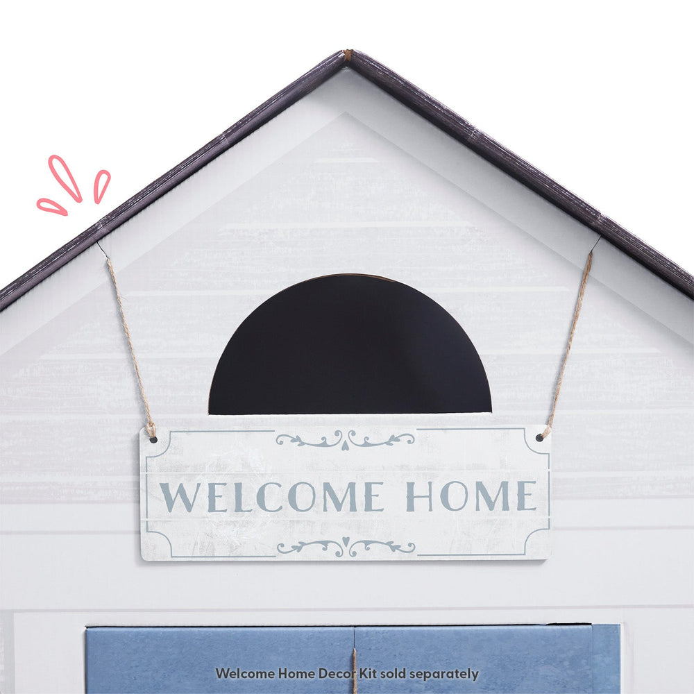 White play house with a 'Welcome Home' sign on a white background