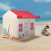 Beach house play tent with red roof on a sandy beach