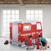 Children playing with a fire truck play tent in a room with large windows.
