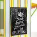 Black sign with white text 'Take a Break, Drink Lemonade' on a striped tent