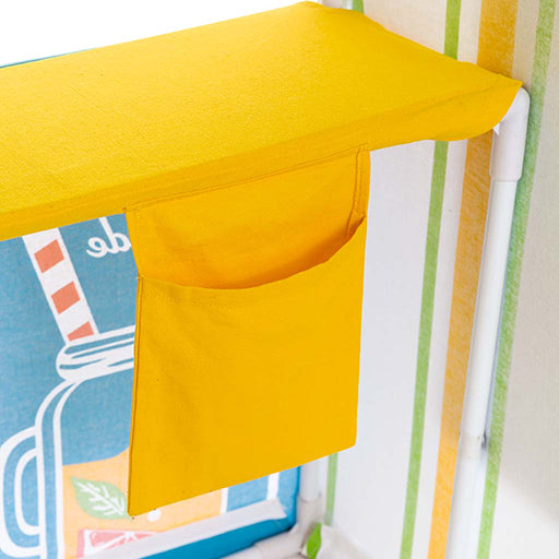 Yellow fabric pocket attached to a play tent with colorful fabric background