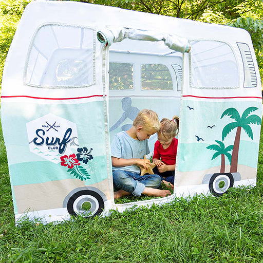 Children playing inside a vintage van-shaped play tent with palm trees and 'Surf Club' design on a grassy background.