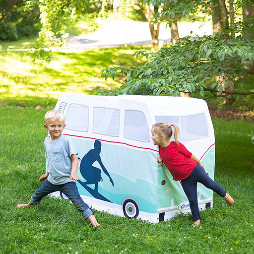 Two children playing with a vintage-style camper van play tent outdoors.