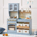 Children's play kitchen set with blue cabinets, wooden shelves, and various accessories on a light background.