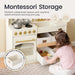 Children's play kitchen set with storage drawers and a child interacting with it, labeled 'Montessori Storage'.