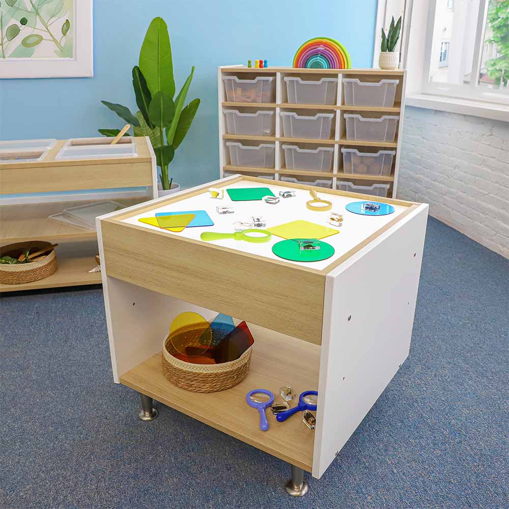 Children's light table with educational toys in a classroom setting