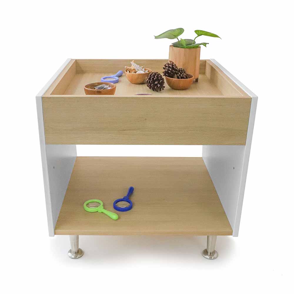 Wooden activity table with toys and items on a white background