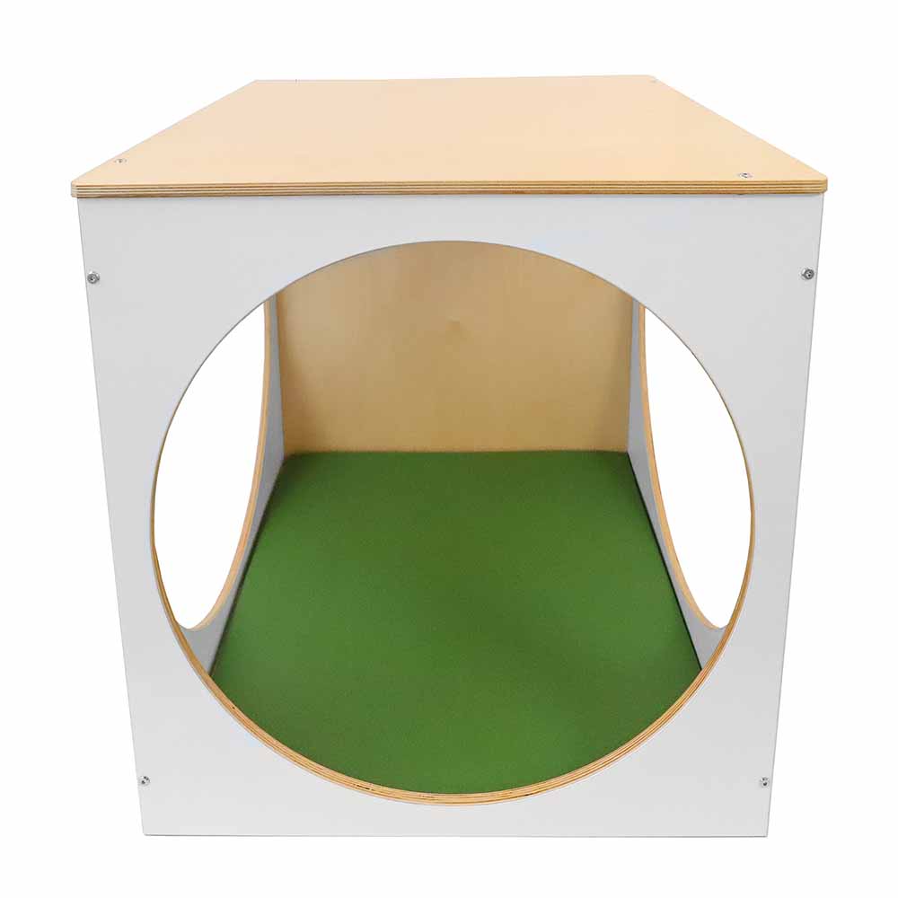 Wooden play cube with a green mat on a white background