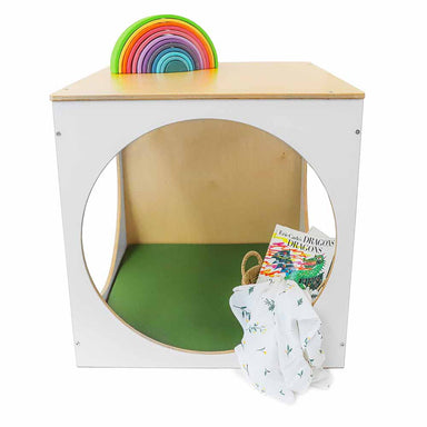 Children's play cube with green mat and toys on a white background