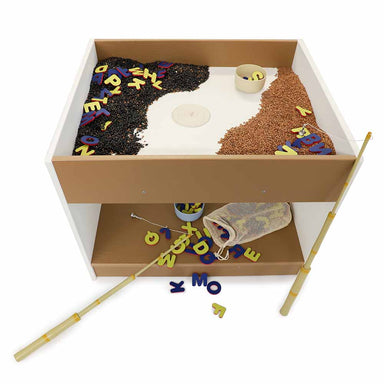 Children's big and wide play table with different materials and letters on a white background