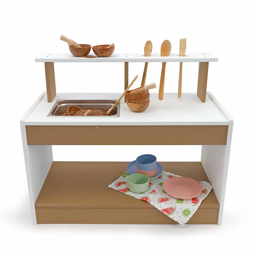 Children's outdoor play mud kitchen set with wooden utensils and bowls on a white background