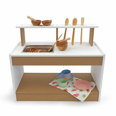 Children's outdoor play mud kitchen set with wooden utensils and bowls on a white background